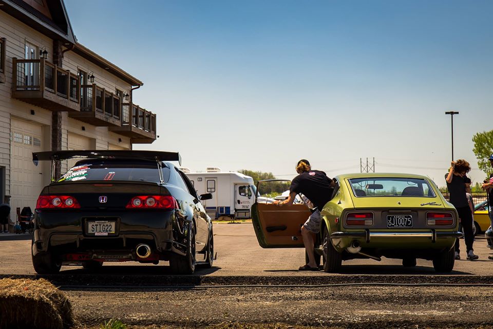 two cars parked at an unnaturally aspirated car community show in Kansas City